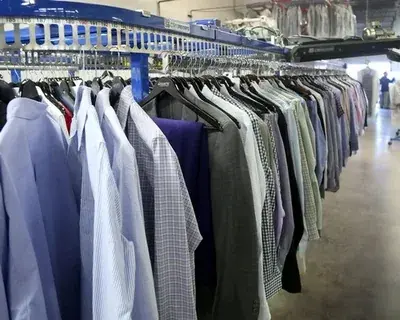 Garments arranged on a rail for collection