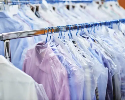 Pressed shirts hanging on a garment rail